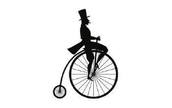 Silouette of man in top hat on old fashioned bicycle