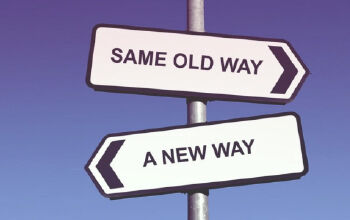 Sign post with 'Same Old Way' and 'A New Way' directions