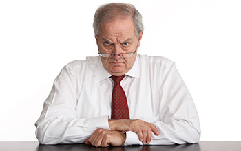 Unhappy man in business clothes staring at you